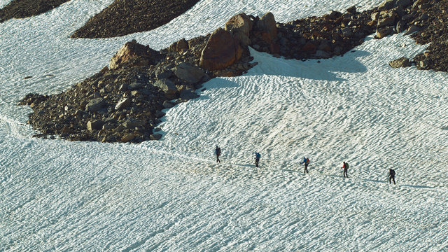 Group of walking Tourists on the Snowfield