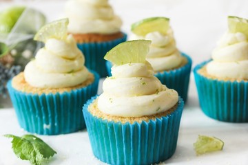 Homemade Key lime cupcakes with cream cheese lime zest frosting, selective focus