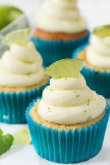 Homemade Key lime cupcakes with cream cheese lime zest frosting, selective focus