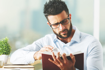 Attractive man reading book
