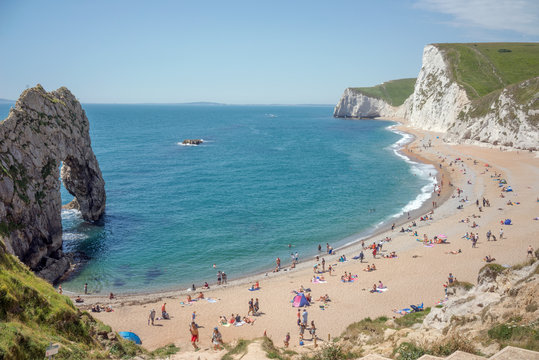 Durdle Door Beach In Dorset, UK On A Sunny Summer's Day