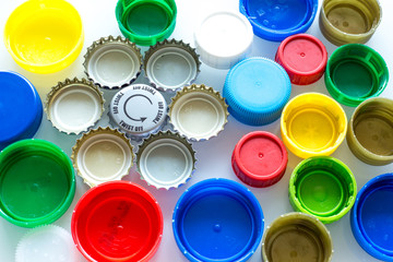 Plastic nuts and caps on a white background / recycling concept