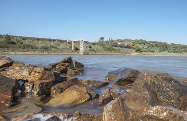 Fototapeta na wymiar Dam of Cornalvo Reservoir from shore, Spain
