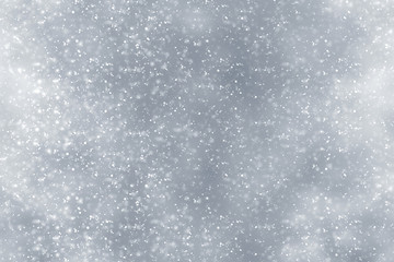 Obraz premium Snowflakes particles and bokeh or glitter lights on silver background. Christmas abstract template