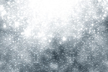 Snowflakes rays and bokeh or glitter lights on silver background. Christmas abstract template
