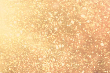 Golden rays and sparkles or glitter lights. Merry Christmas festive gold background.defocused circle bokeh or particles