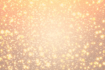 Golden rays and sparkles or glitter lights. Merry Christmas festive gold background.defocused circle bokeh or particles