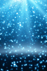 Obraz premium Abstract bokeh glitter lights and rays on blue background. Round defocused circle particles. Christmas template