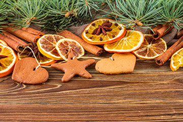 Dried oranges, star anise, cinnamon sticks and gingerbread on a wooden background -- Christmas still life background