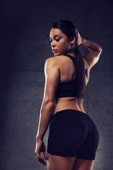 Fototapeta na wymiar young woman posing and showing buttocks in gym