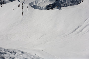Snowboarders and skiers downhill on off piste slope. Top view. Caucasus Mountains, Georgia, ski...