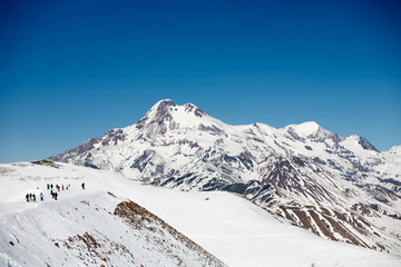 Fototapeta na wymiar View on ski slope and beautiful mountains in evening. Ski resort Gudauri, Caucasus Mountains, Georgia