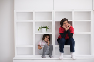 young boys posing on a shelf