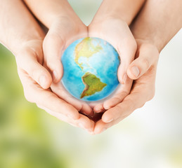 woman and man hands holding earth planet