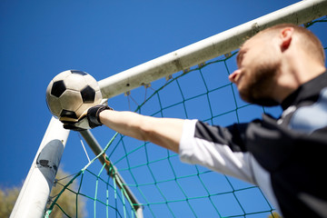 goalkeeper with ball at football goal on field