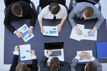business team at a seminar discussing financial charts of the Co