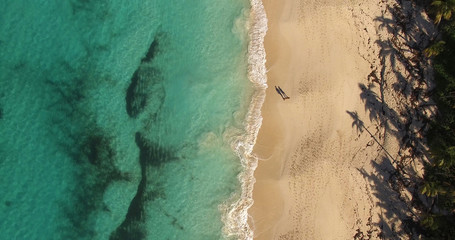 Fototapeta na wymiar Top View of a Couple Shadow in Paradise Beach, Bahamas