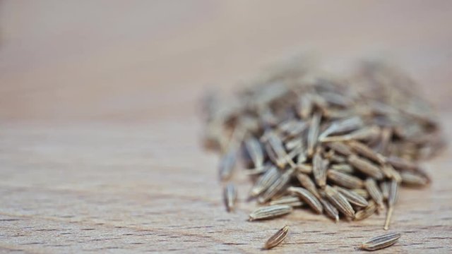 cumin lying on a wooden Board.