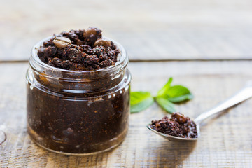 Spa concept with natural coffee scrub on wooden table background