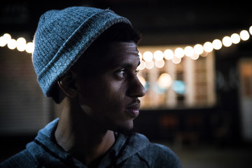 Portrait of a young, black hipster at night in Brooklyn