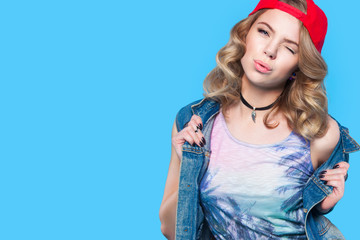 young pretty teenager girl emotional posing on blue background, fashion lifestyle people concept