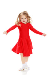 Girl dancing in a bright red dress.