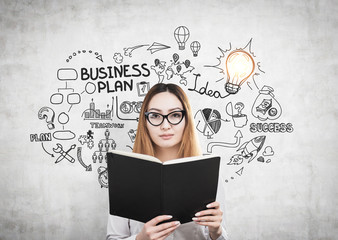 Woman with book and a business plan