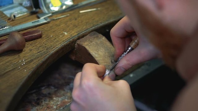 Precious stone is fixed in a silver ring by the hands of goldsmith