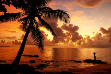 Naklejka premium Colorful sunrise on the beach in Lavena village in Taveuni Island, Fiji