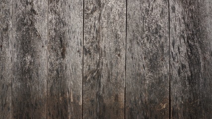 Wooden background of old grey brown fence with rusty nails.