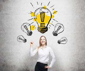 Woman pointing at a light bulb
