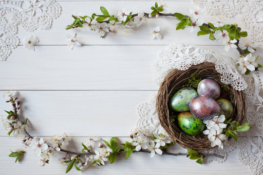 Easter background with a nest, eggs and branch with flowers