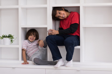 young boys posing on a shelf