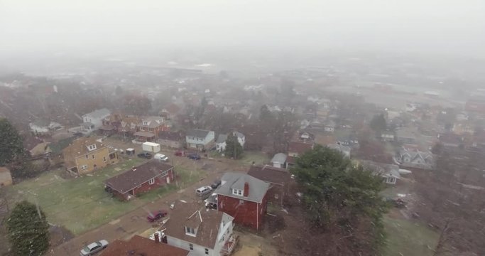 A slowly rotating aerial snowing winter view of a typical Western Pennsylvania residential neighborhood.	 	