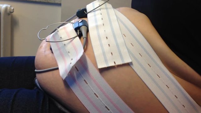 Pregnant tummy with senors to make sure the baby is OK. Filmed in a maternity ward