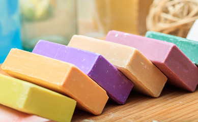 Variety of soap bars on wooden background