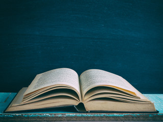 old book open on a wooden table