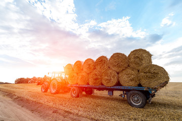 Sunset above the tractor with a trailer © Stockr