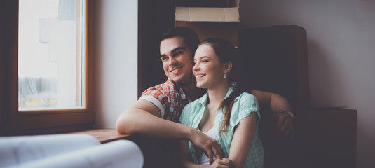 Portrait of young couple moving in new home