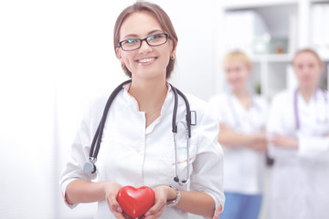 Doctor with stethoscope holding heart, isolated on white background