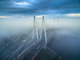 The cable-stayed bridge in the fog. Bridge across the river in dense fog. St. Petersburg. Fog in the city.