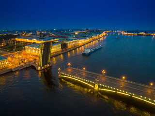 A divorced bridge with a floating ship. Neva River. Night city of St. Petersburg.