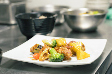 Chicken and vegetable .intermix in vinegar sauce  put on white plate