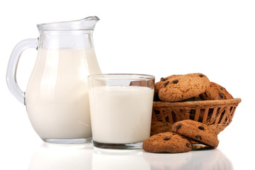 jug and glass of milk with oatmeal cookies in a wicker basket isolated on white background