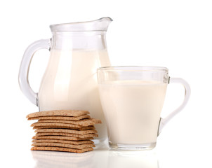 jug and glass of milk with stack of grain crispbreads isolated on white background
