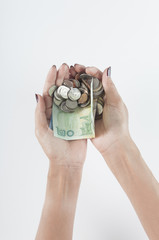Fototapeta premium Woman hand holds heap of thailand currency with coins and banknotes