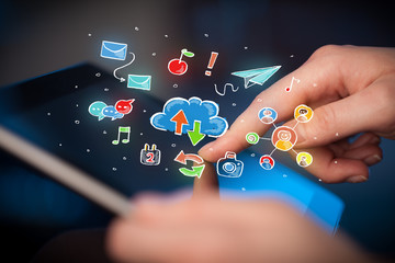 Fingers touching tablet with social icons