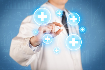A doctor showing a pill with crosses