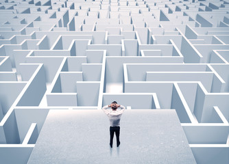 Businessman staring at infinite maze