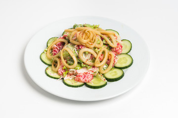 Plate of salad on white background